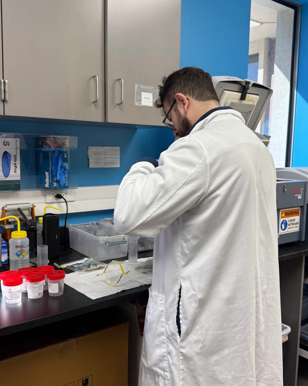 An analyst weighing out a sample at the bench