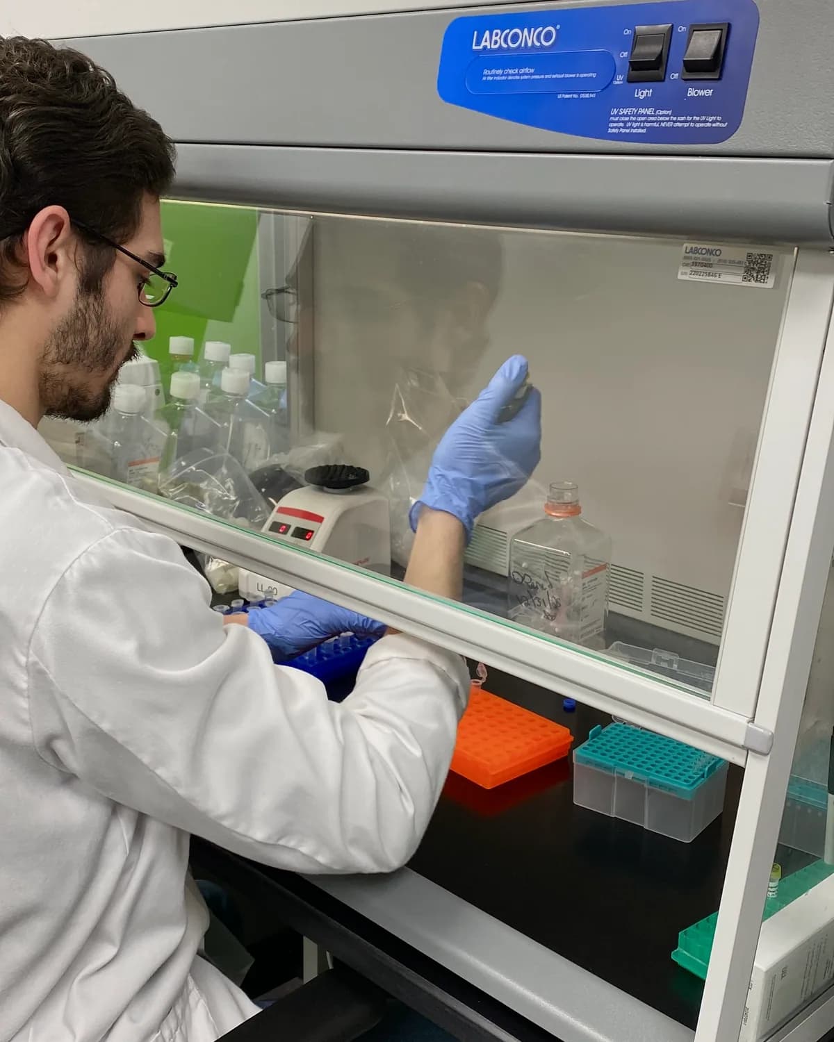 An analyst preparing samples inside a fume hood