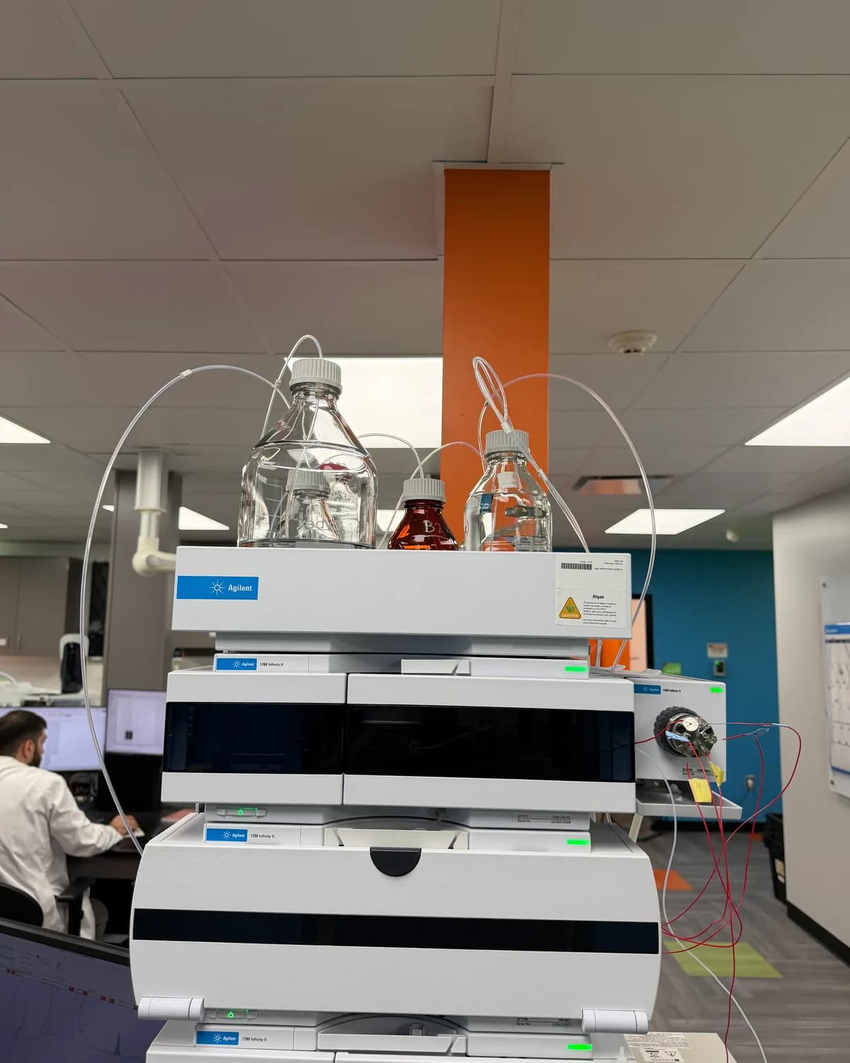 An HPLC system running with an analyst at the screen