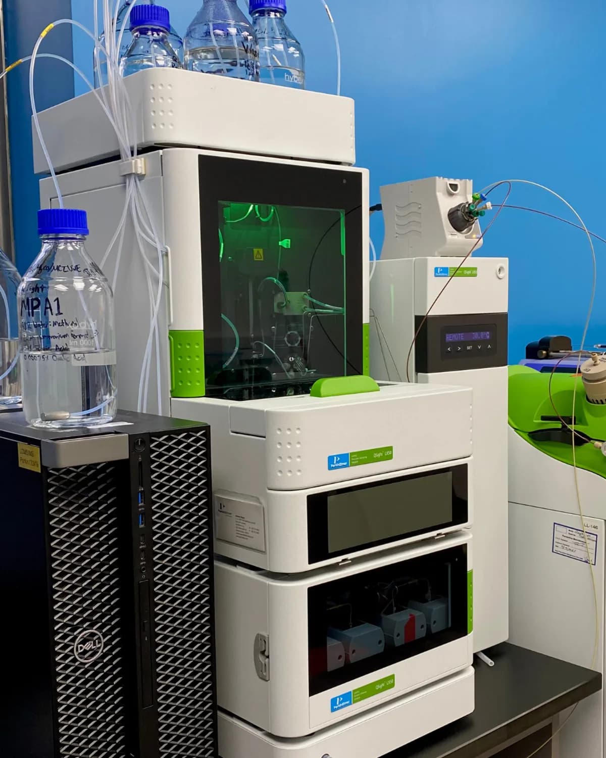 An LC-MS/MS system lit green in the instrument room